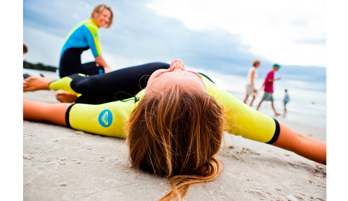 This is an image of Sally Fitzgibbons warming before paddling out with Torah Bright at the Quiksilver Pro New York in 2011. I was hired by Roxy to shoot all of their events and promo stuff at the suggestion of my friend Nick Zegel, who threw my name into the mix of photogs to consider hiring. I was in heaven. Jenny Pham and the whole crew at Roxy were so easy to work with. Not only because because I was shooting the beauties that the Roxy surf team is, but because I was doing what I loved: documenting surfing. I was seriously living the dream that week. Photo: <a href=\"http://www.ryanstruck.com/\"> Ryan Struck</a>