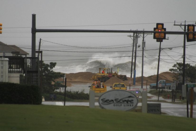 This is Kitty Hawk as Sandy was passing by. Do you see the hardy bulldozer driver fighting to fill a breach in the dune line? Photo: McCarthy