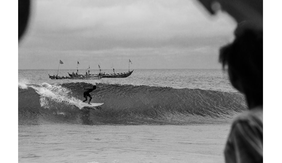 President of the Liberian Surfing Federation, Benjamin McCrumuda, showing off for his fishermen friends. Photo: Sean Brody