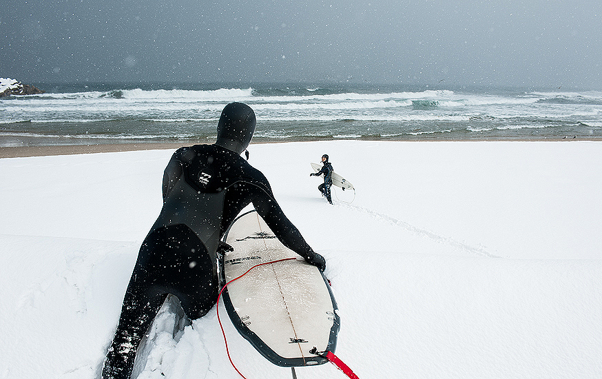 Korean surfers, Moonjun Bae and Young-ik Son, clamber over huge snowdrifts to get out there for a couple of chilly peaks. Photo: <a href=\"http://www.shannonaston.com/\" target=_blank>Shannon Aston</a>.