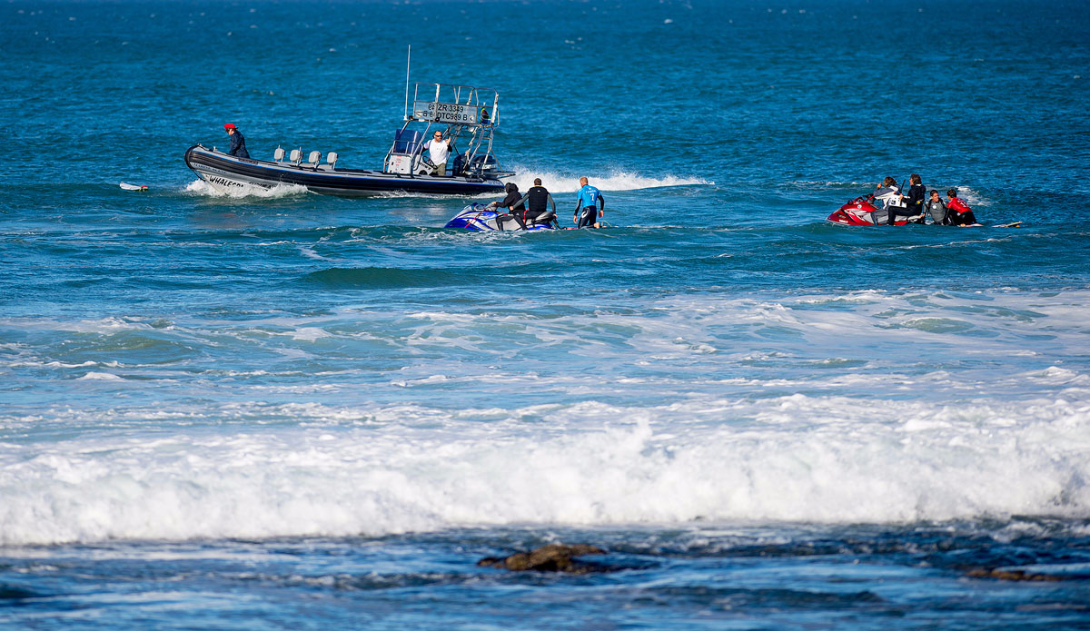 Mick Fanning of Australia (pictured blue) and Julian Wilson (red) are taken to the safety boat after Fanning was attacked by a shark during the Final of the JBay Open on Sunday July 19, 2015. Photo: <a href=\"http://www.worldsurfleague.com/\">WSL</a>/<a href=\"http://www.instagram.com/kirstinscholtz\">Kirstin Scholtz</a>