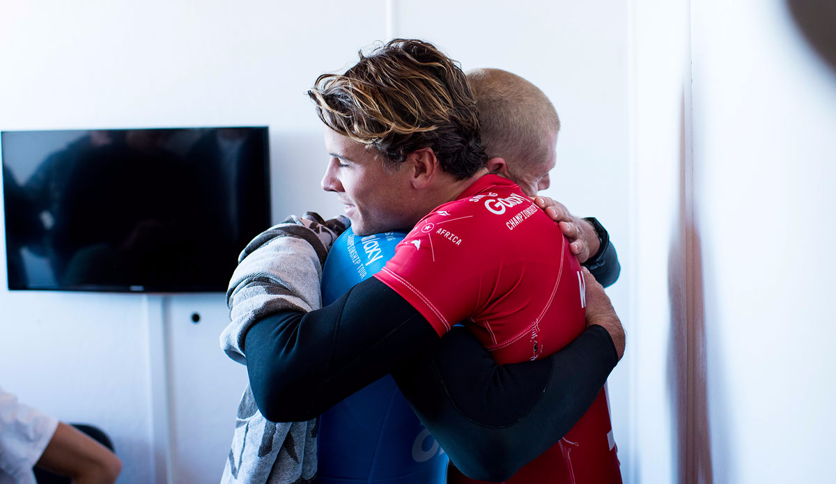 JBay Open Finalists Mick Fanning of Australia (pictured blue) is hugged by Julian Wilson of Australia after being attacked by a shark during the Final of the JBay Open on Sunday July 19, 2015. 