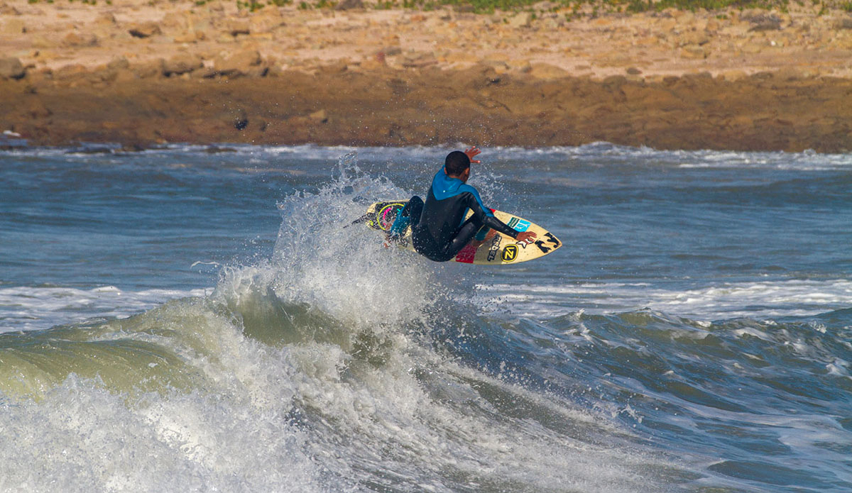 Mini grom Dillen Hendricks pushing S.A junior surfing with jumps like this. Photo: <a href=\"https://www.facebook.com/pages/Pho-Tye-Studio/398591356893177?fref=nf\"> Tyerell Jordaan</a>