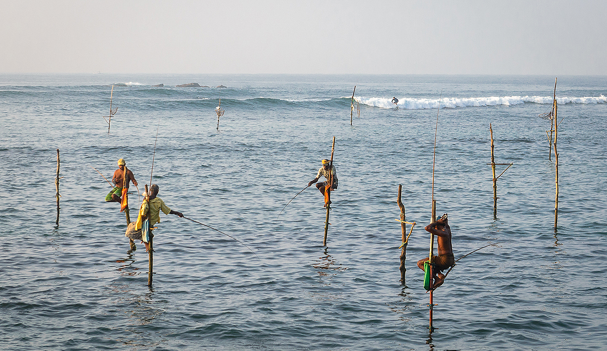 Local living mixes right in with the surf in Sri Lanka. Photo: Charles Audet