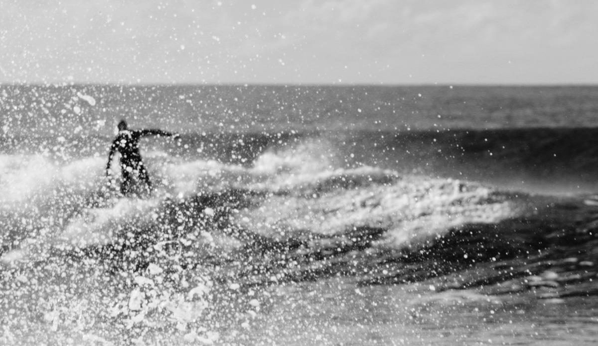 Glimpse. An unknown surfer attempts to avoid getting himself in the frame from an unexpected burst of water. Photo: <a href=\"http://rickycavarra.com\">Ricky Cavarra</a>