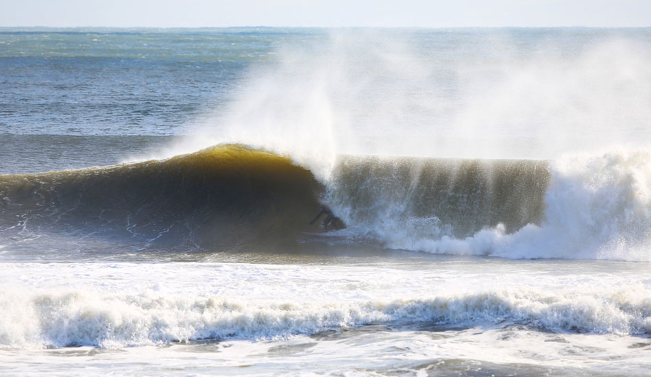 Glide Surf Co. owner, Phil Browne, pulling into a throaty one. Photo: <a href=\"http://www.rozbernsurf.com\":> Kevin Strickland</a>