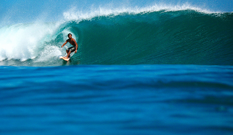 Eddy \'Bagus\' starts off his Saturday morning right with this perfect blue sloper in the Bali Bukit. Photo: <a href= \"http://tommyschultz.com/blog/category/photo-galleries/surf-photography-2/\">Tommy Schultz</a>