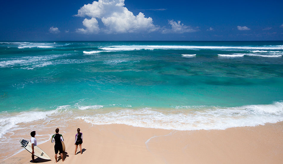 Bali\'s Kuta Beach is where surfing first started on the island, but if you want to beat the high-season crowds you have to get off the beaten track. Eddie \'Bagus\', Steve, and Cissy have their choice of an empty lineup and an open Indian Ocean horizon. Photo: <a href= \"http://tommyschultz.com/blog/category/photo-galleries/surf-photography-2/\">Tommy Schultz</a>