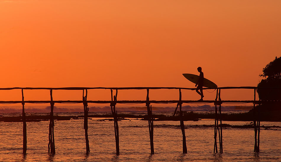 Cloud 9 in Siargao might have been named after a marshmallow and chocolate candy bar, but there\'s nothing tasty about its new nickname \'Crowd 9\'. When the rest of the island is sleeping off a few too many San Miguel\'s, you could be catching a Pacific sunrise (and uncrowded waves) like this guy heading out the pier at dawn. Photo: <a href= \"http://tommyschultz.com/blog/category/photo-galleries/surf-photography-2/\">Tommy Schultz</a>