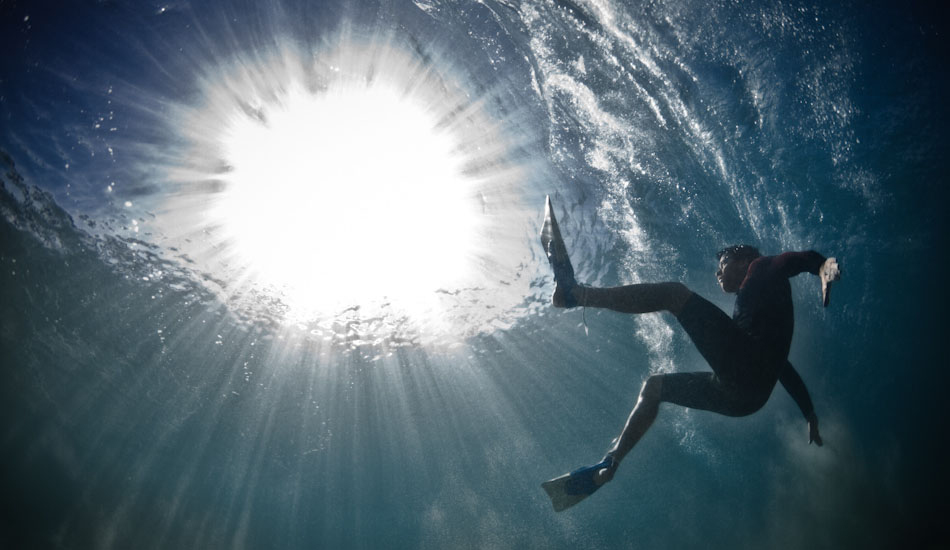 Shine. Mike Hemus looks at the sun as a wave passes in the remote South Australian Outback. “After shooting Escape, I spent a fair bit of time thinking where to shoot and what to do with the project. We drove four hours from Adelaide with a number of angles that we wanted to shoot, and after 6 hours in the water we found that the in-between poses and intended shots were the ones that held the emotion I was looking for.” Photo: <a href=\"http://www.marktipple.com/\" target=_blank>Mark Tipple</a>.
