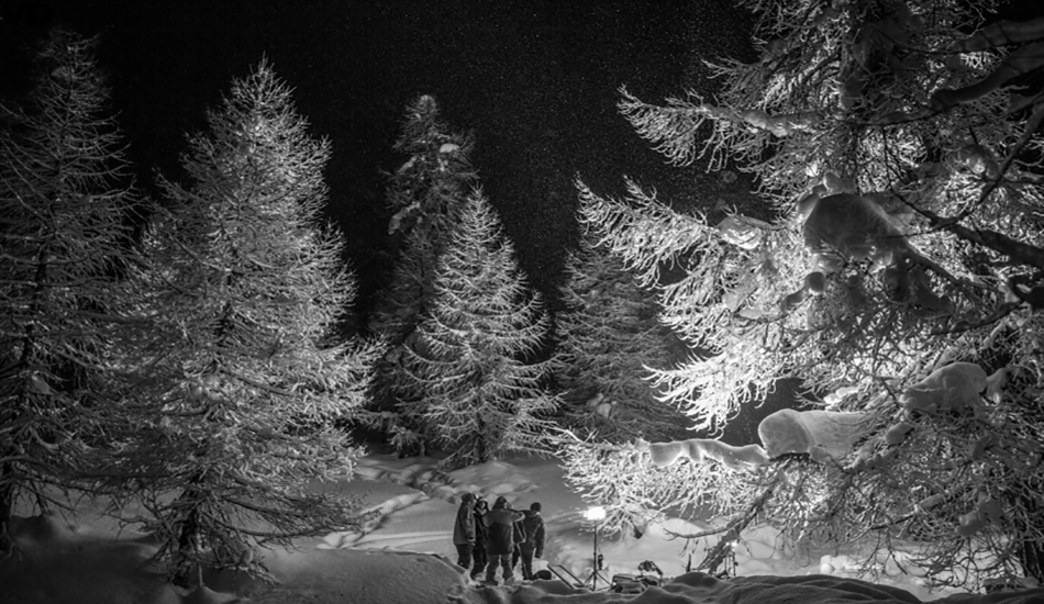 One night we dragged two generators, 10 lights, 10 tripods and 200 meters of cables up a snowy path. It was hard work but we all had a sense of adventure and enjoyed the night. It started snowing at some point and I just walked away from the crew and took this picture. It turned out to be the most memorable image from the whole shoot.