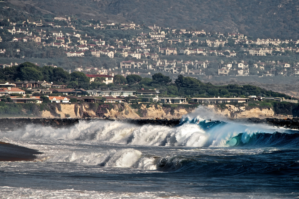 From this vantage it seems as though all of Newport Beach is focused on Wedge, and that suits Bobby Okvist just fine as he dropps this massive peak during the Hurricane Marie swell. Photo: Benjamin Ginsberg / Driftwood Photography Studios