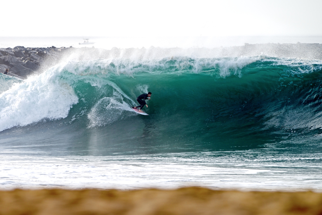 Tyler Stanaland does it all at Wedge from skimboarding to surfing. It\'s that familiarity which allows him to pull under the lip with such ease. Photo: Benjamin Ginsberg / Driftwood Photography Studios