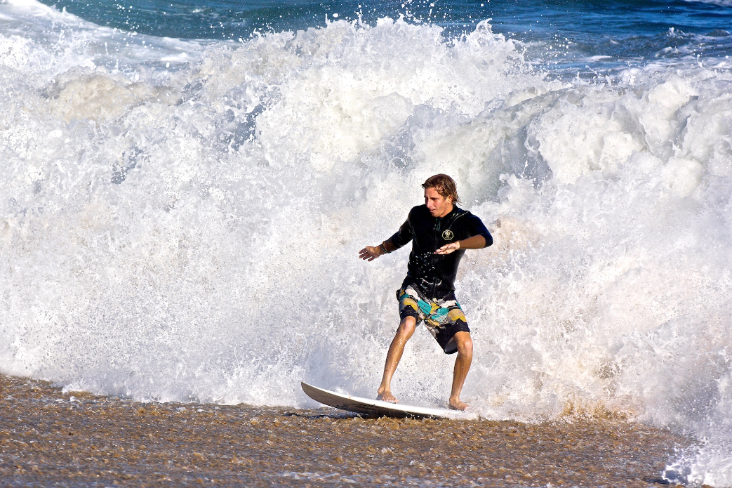 Bobby Okvist has a close encounter with the sand after escaping out of a doggy-door exit from a draining shore break barrel at Wedge. Photo: Benjamin Ginsberg / Driftwood Photography Studios