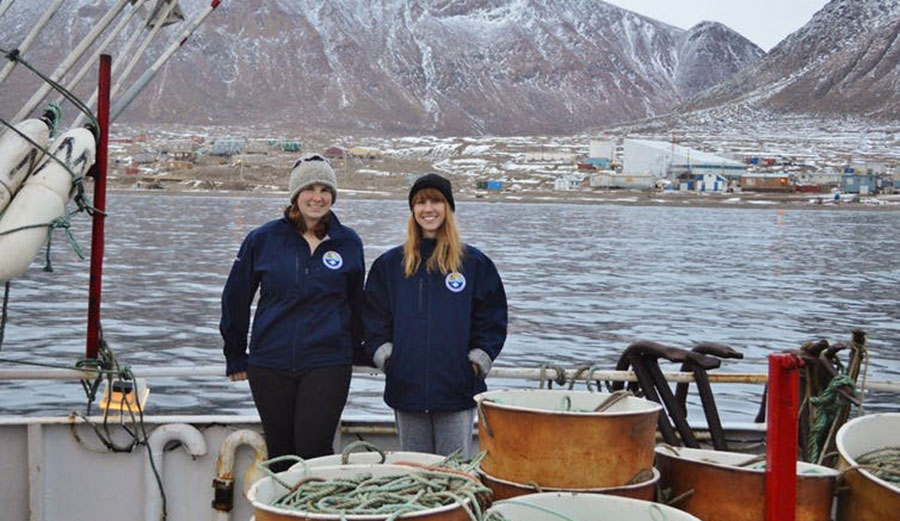 Researchers Brynn Devine (right) and Laura Wheeland aboard the vessel Kiviuq I off the community of Grise Fiord on southern Ellesmere Island in 2016. Image: Laura Wheeland/ Author provided