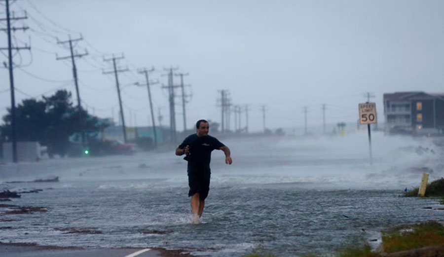 Wind pushes water over Highway 64 as Hurricane Arthur passes through Nags Head, North Carolina, July 4, 2014.