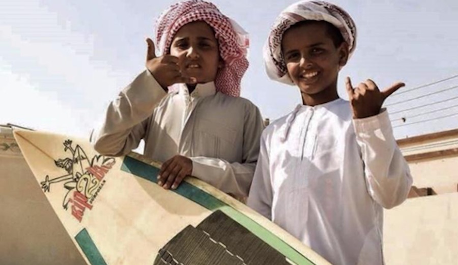 Oman kids with a surfboard