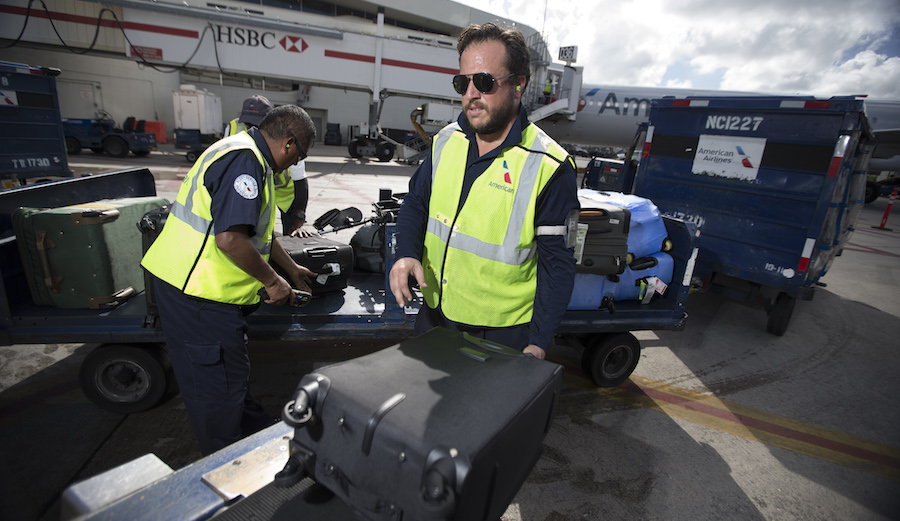 American Airlines fleet team member loading baggage.