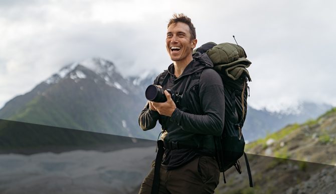 Photographer Chris Burkard smiling with his camera