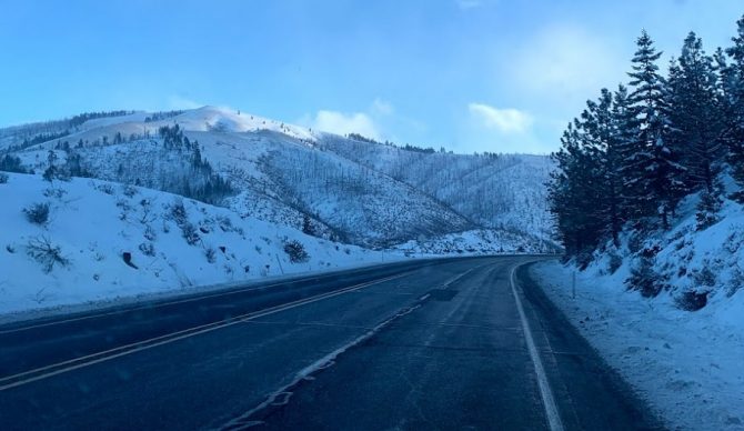 road in the snow with mountains will sileo