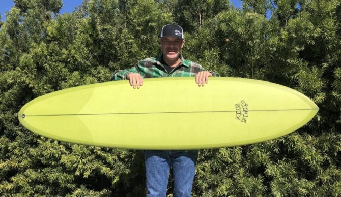 erik smelly sandin with a pickestix surfboard