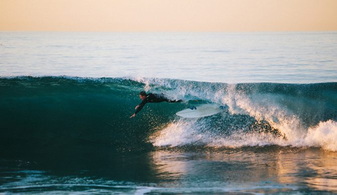 a surfer wipes out in the barrel