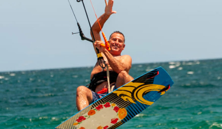 Fred Salter is shown kitesurfing 