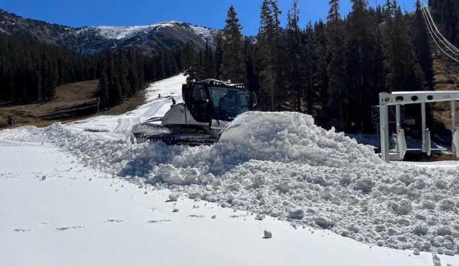 snowcat pushing snow at a-basin