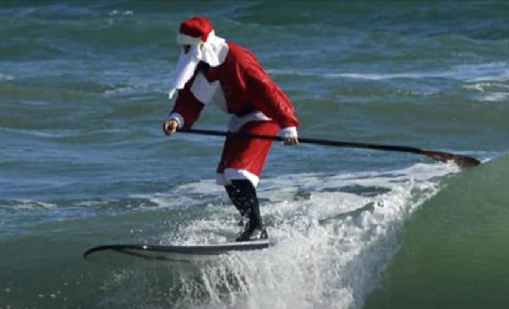 NO FILM, NO VIDEO, NO TV, NO DOCUMENTARY - Surfers don Santa outfits during  the Surfing Santas of Cocoa Beach fundraiser in Cocoa Beach, FL, USA, on  Wednesday, December 24, 2014. Hundreds