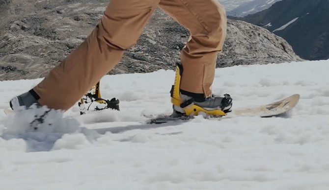 a snowboarder pushes along like a skateboarder