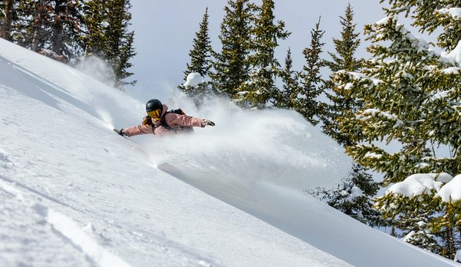 A woman rips powder snow.