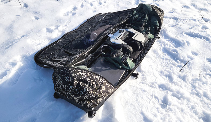 the burton wheelie flight attendant bag loaded with snowboard gear