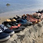 a line of water shoes on a stone wall