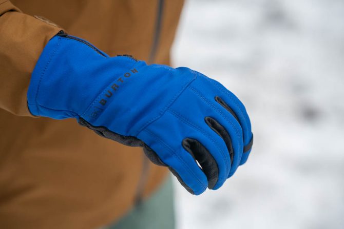 a person wearing the Burton [ak] tech gloves for snowboarding