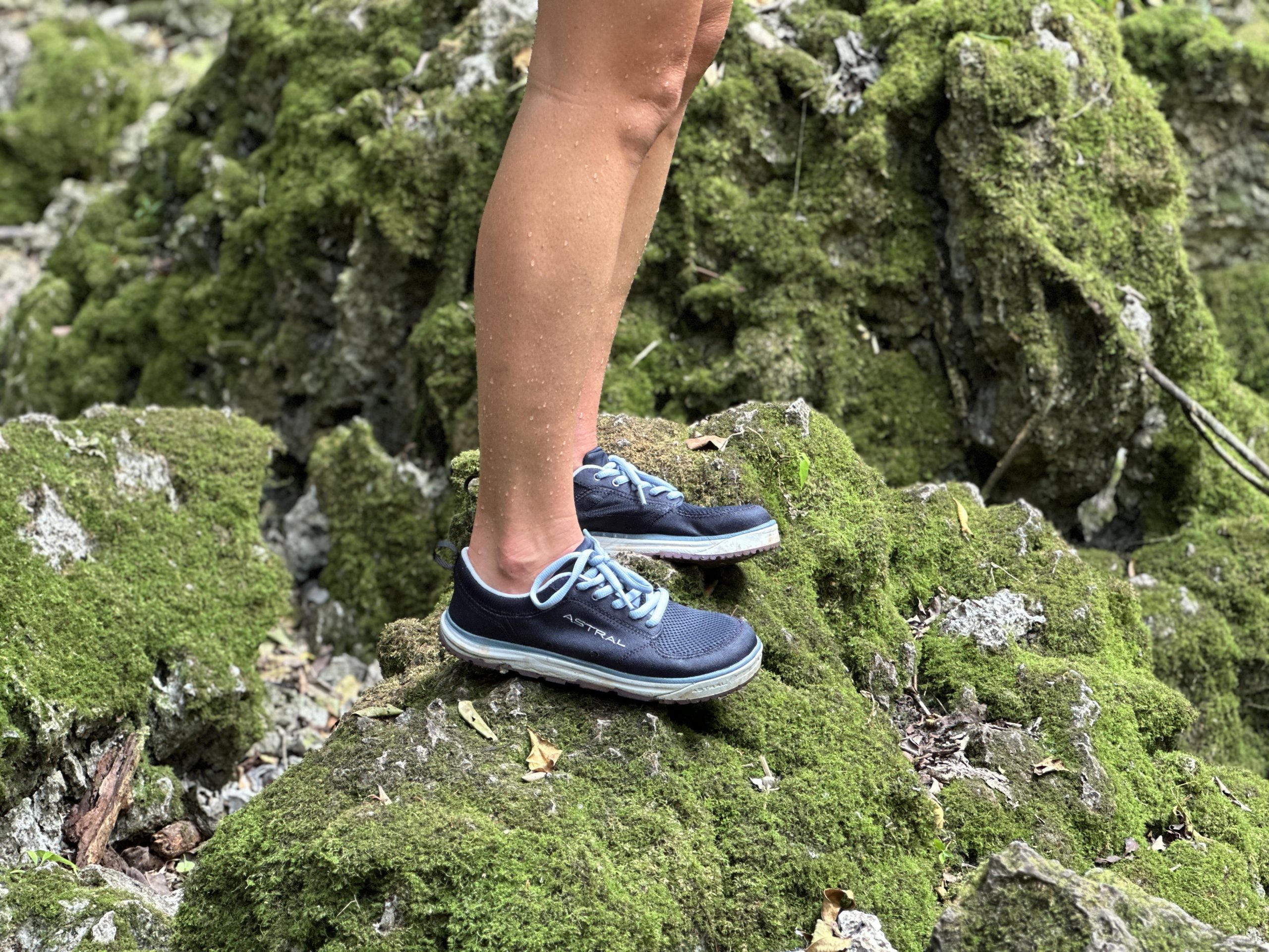 standing on a slippery, mossy rock while wearing astral brewess water shoes