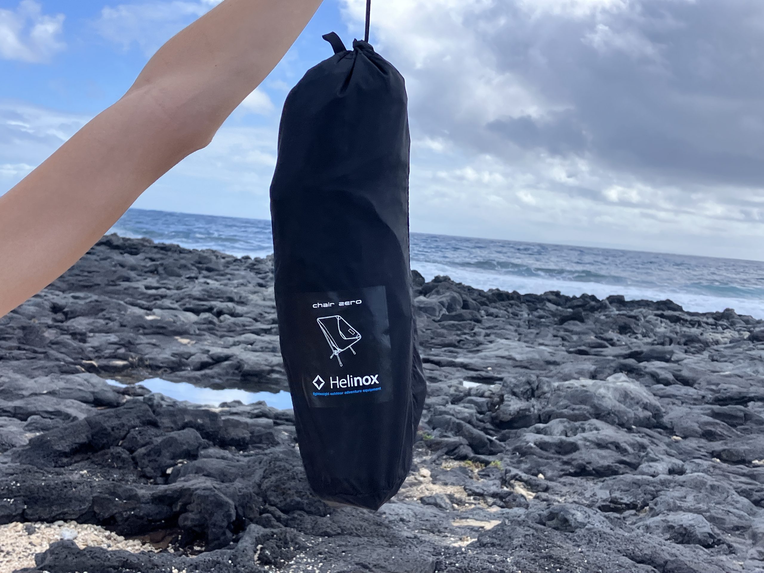 a packed up Helinox chair at the beach