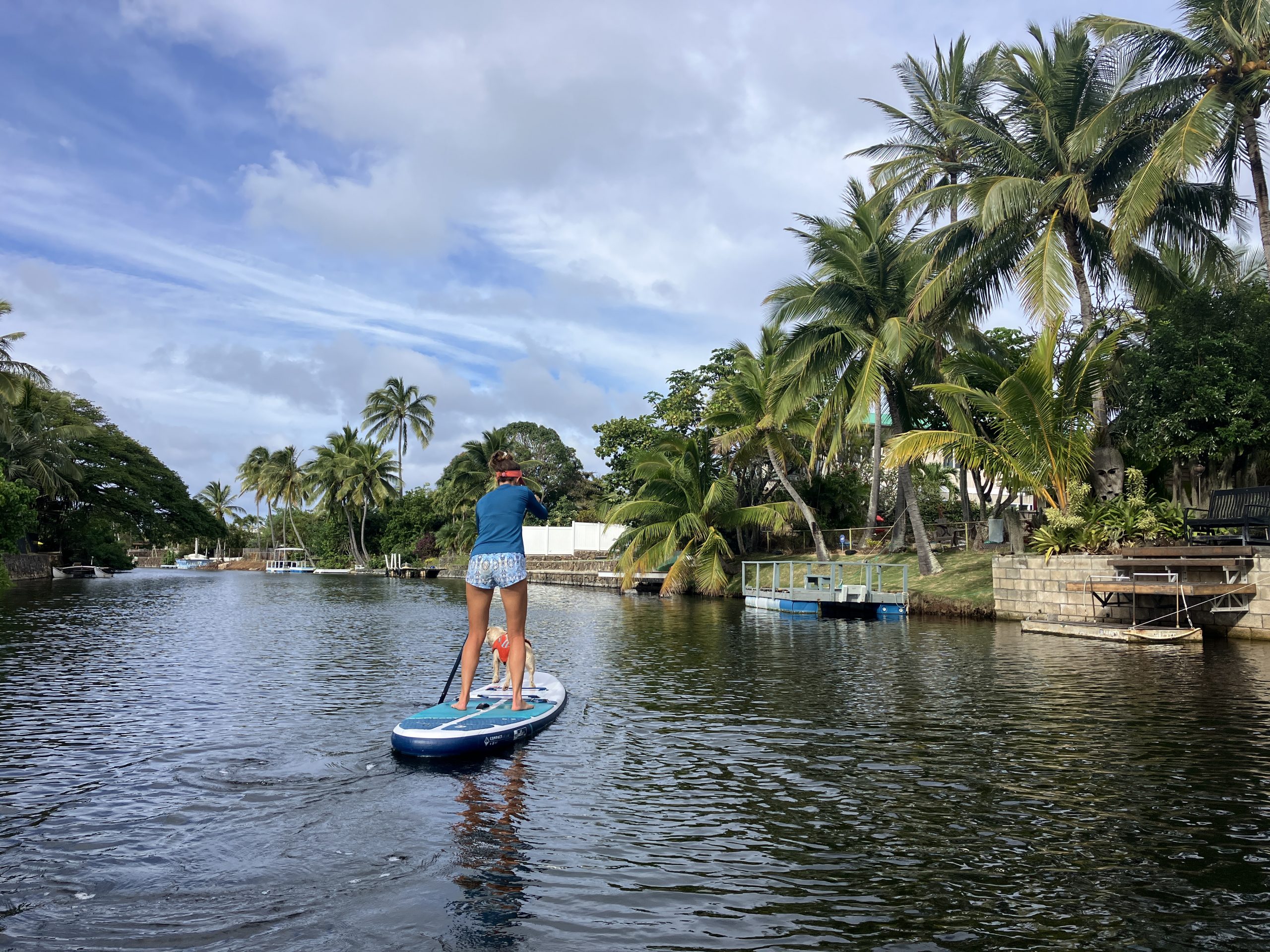 woman paddle boarding in a canal 