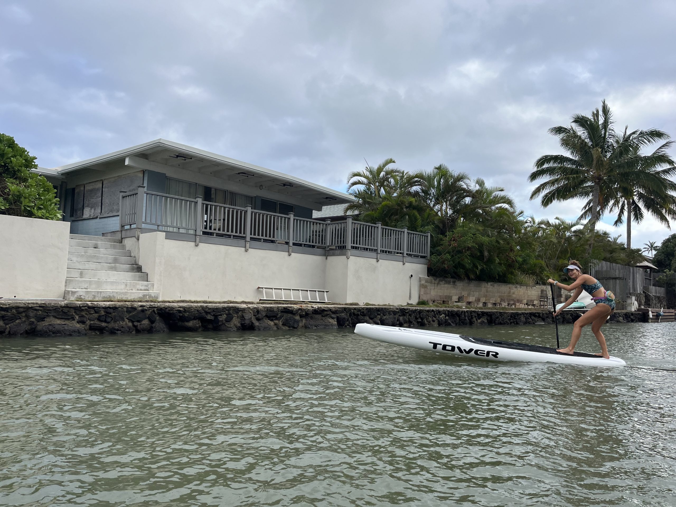 woman turning an inflatable stand up paddle board