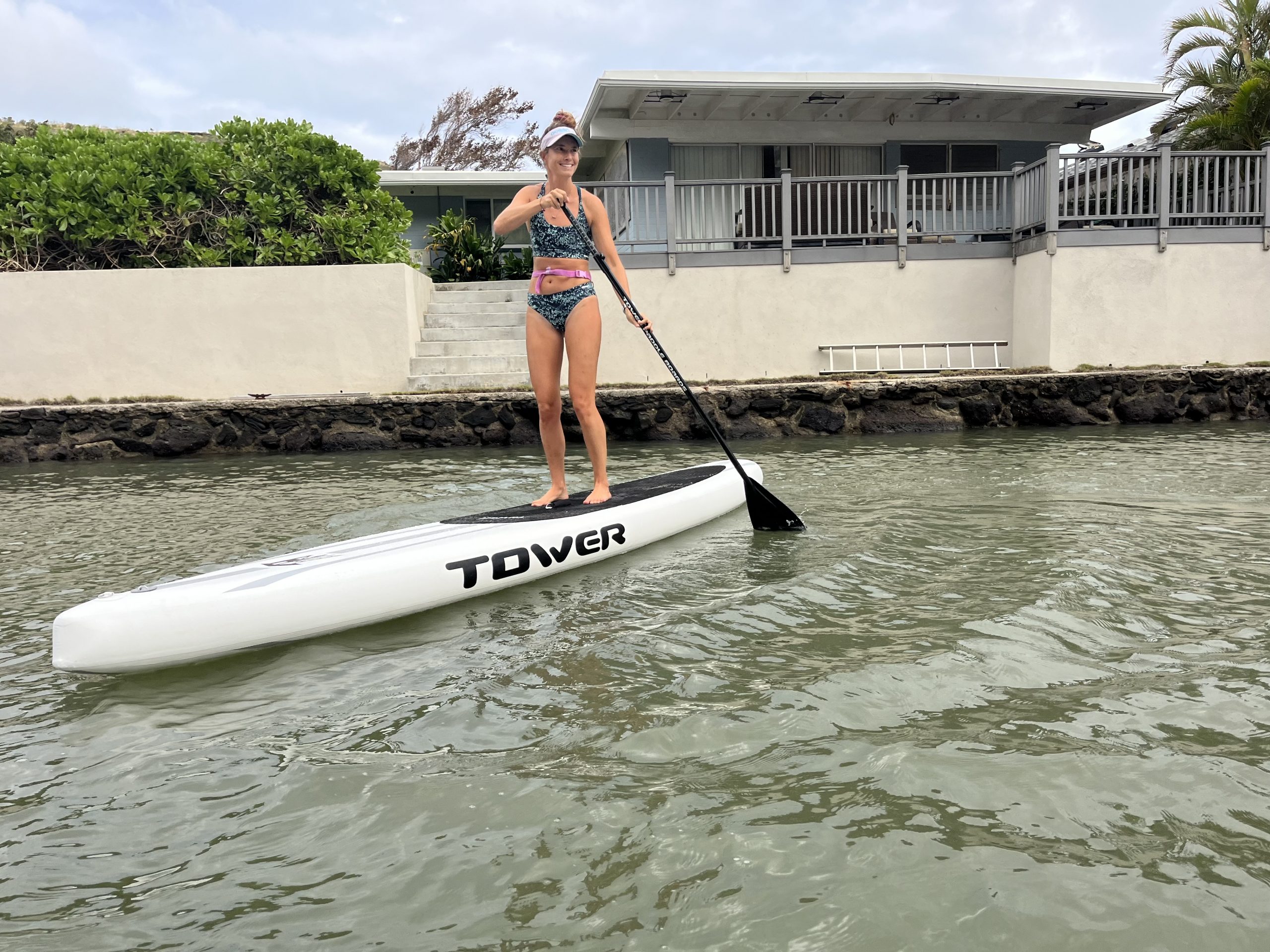 woman paddling a tower inflatable stand up paddle board