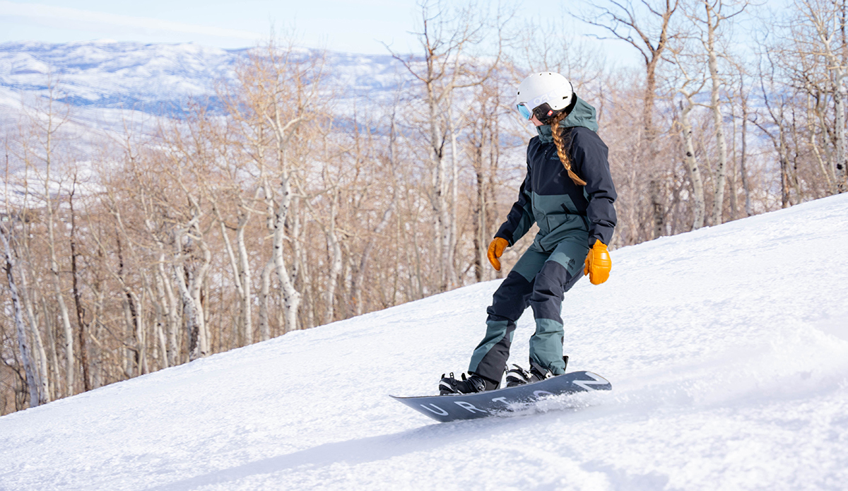 Snowboarding in the Jones MTN Surf Jacket and Bibs