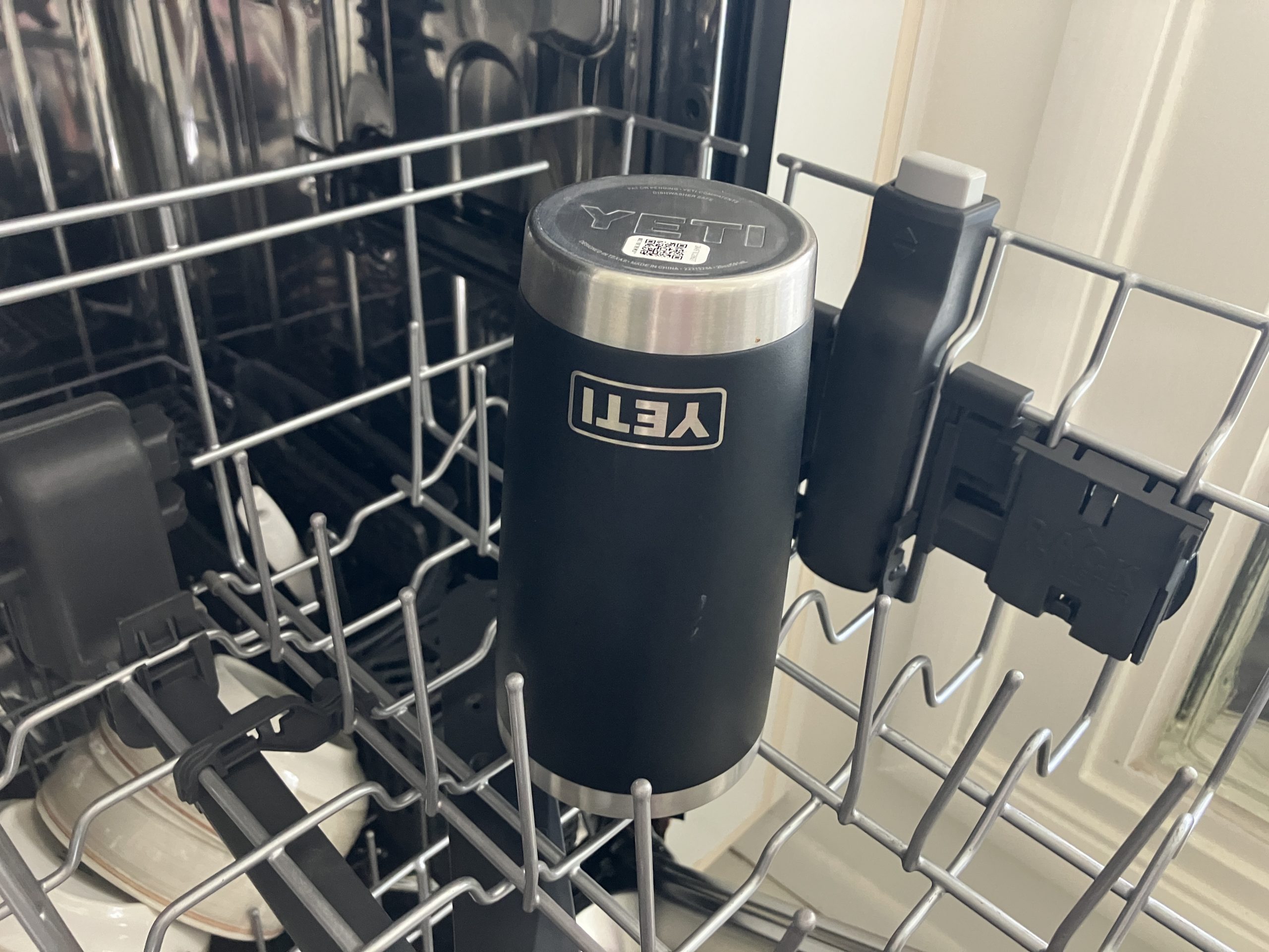 a black YETI insulated coffee mug in the dishwasher