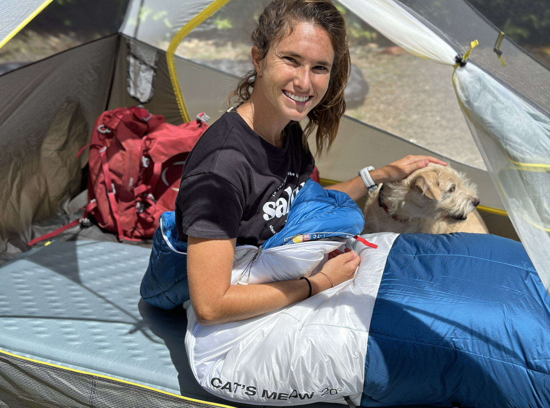 a woman and a dog in a backpacking tent 