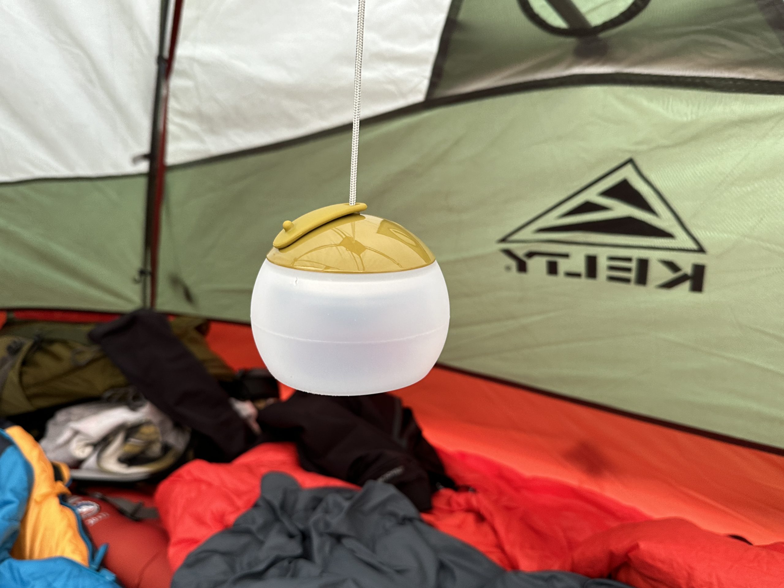 a camping lantern hanging in a tent