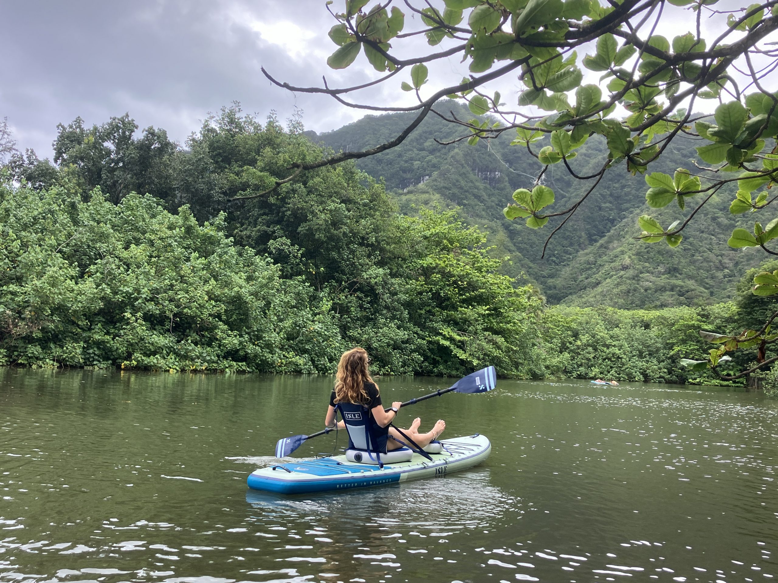 a woman kayaking in a a lagoon