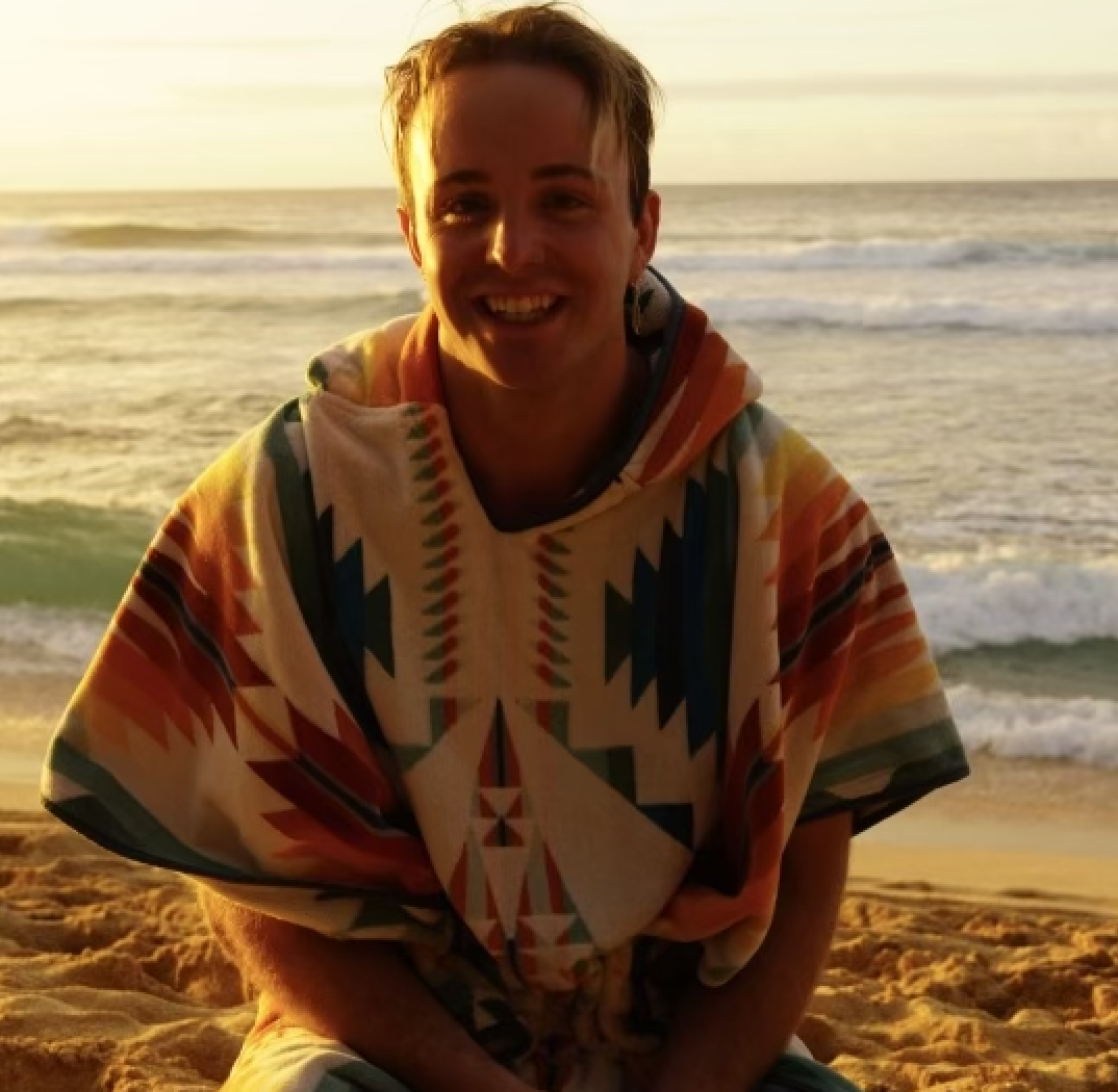 a man in a surf poncho at the beach 