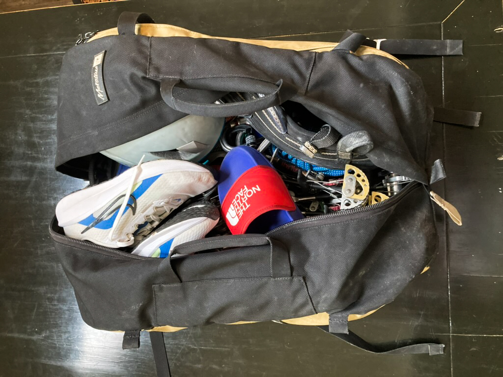 a travel backpack open with gym gear