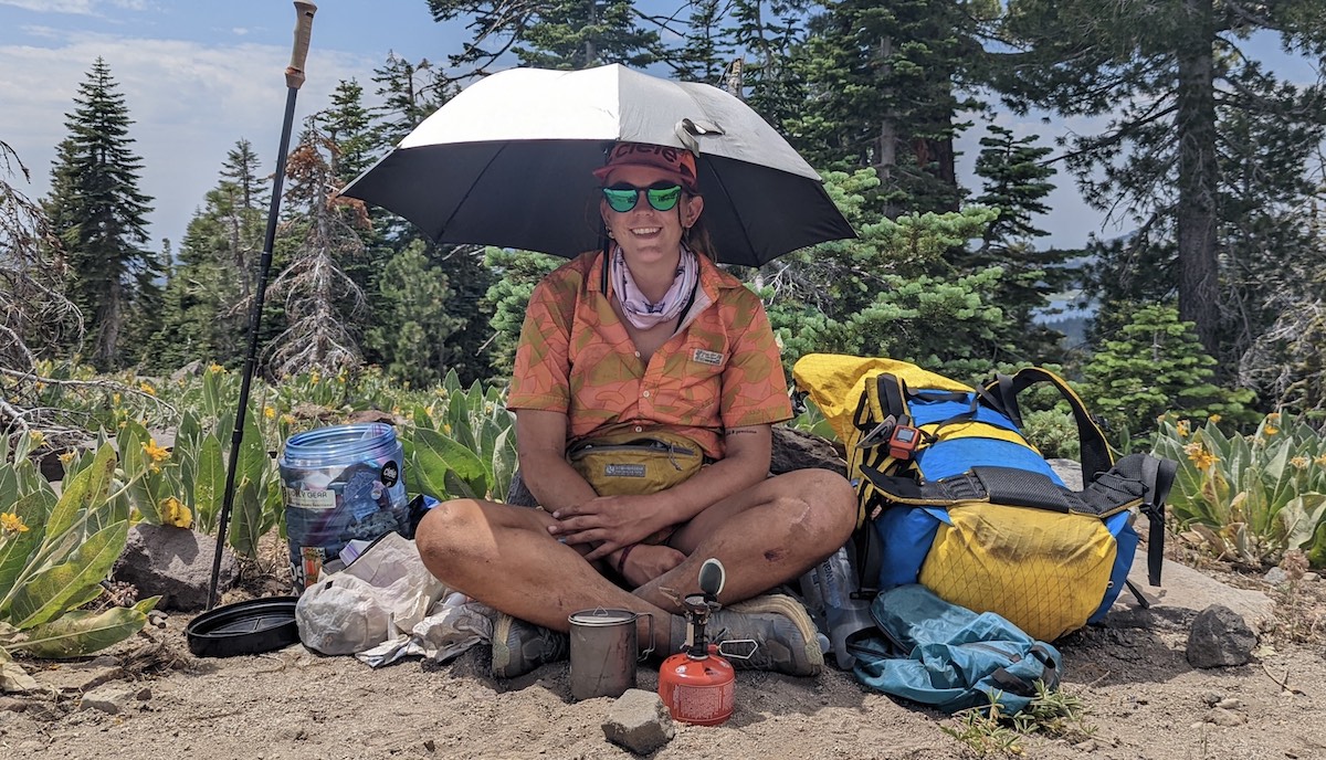 A hiker shelters from the sun during her long, long walk. Photo: Kodi Frost