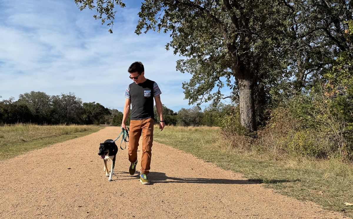 man walking dog in hiking pants