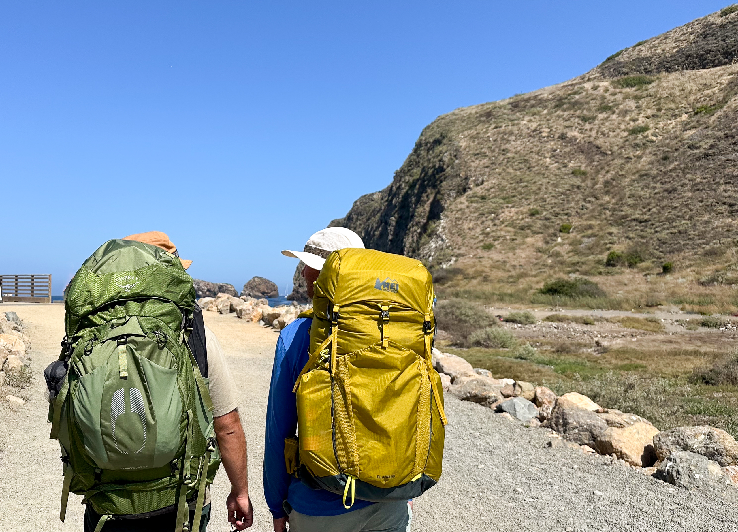 two men walking with backpacking backpacks