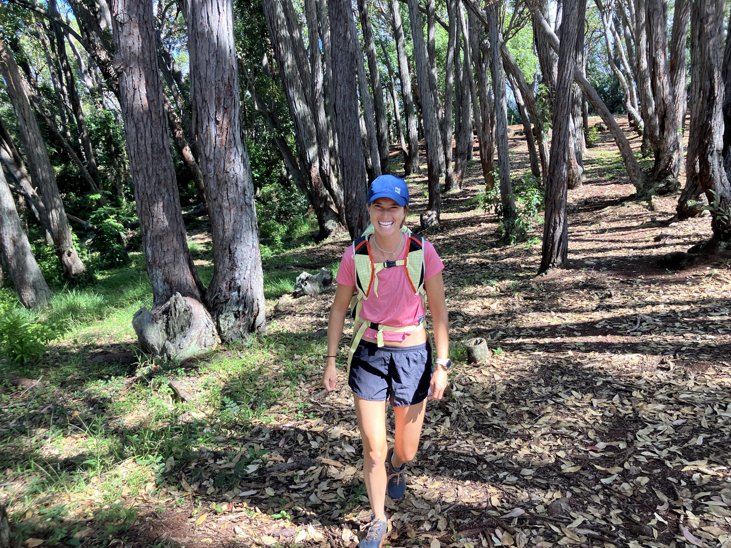 a woman hiking and smiling 